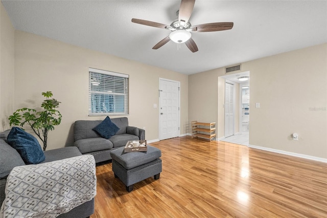 living room with ceiling fan and hardwood / wood-style flooring