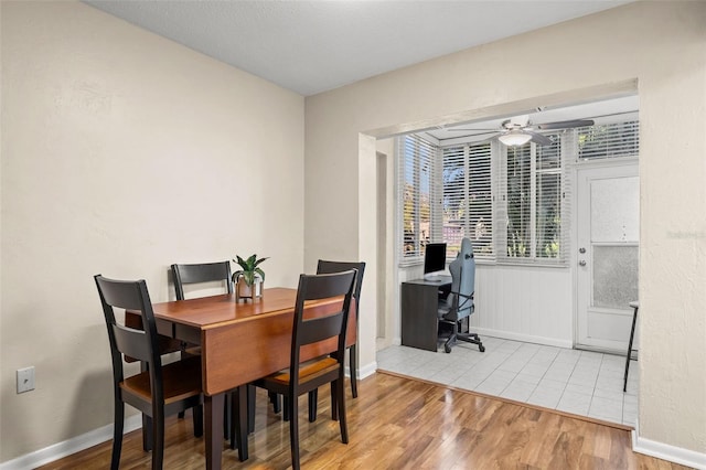 dining area featuring ceiling fan and light tile patterned floors