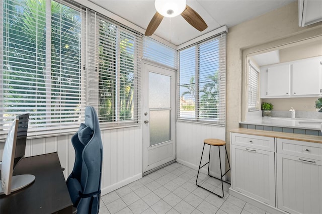 office with light tile patterned floors and ceiling fan