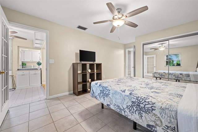 bedroom featuring a closet, ceiling fan, and light tile patterned floors