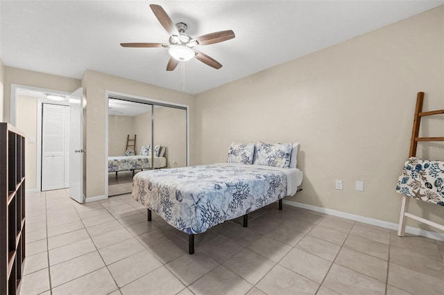 bedroom featuring light tile patterned floors, ceiling fan, and a closet