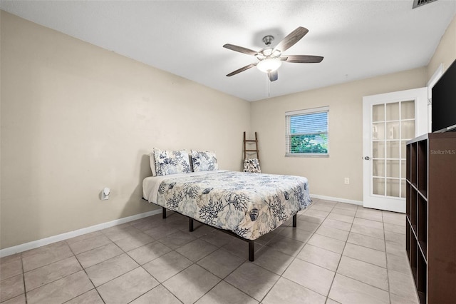 tiled bedroom featuring ceiling fan