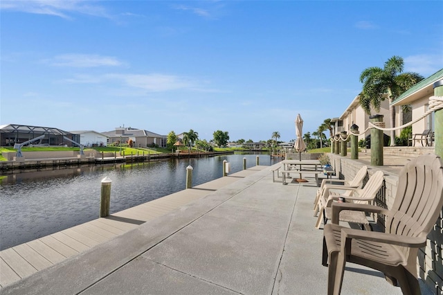 view of dock featuring glass enclosure and a water view