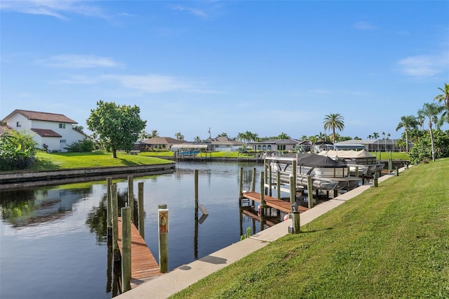 view of dock featuring a yard and a water view