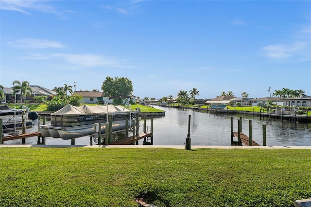 dock area with a water view and a yard