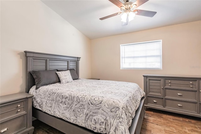 bedroom featuring ceiling fan, vaulted ceiling, and wood finished floors