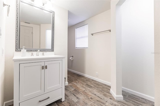 bathroom with hardwood / wood-style floors and vanity