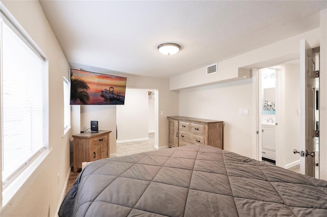 bedroom featuring light hardwood / wood-style floors and sink