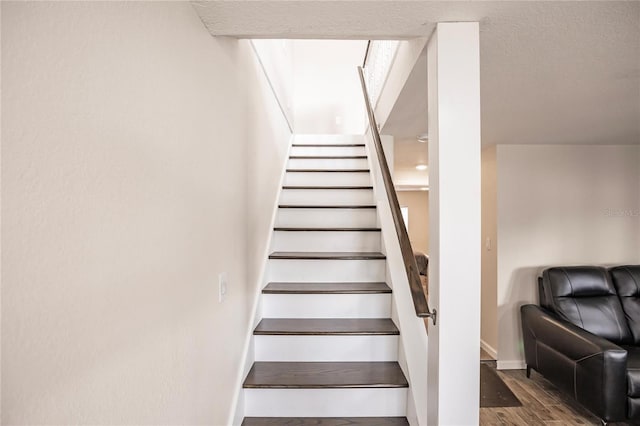 staircase with hardwood / wood-style flooring