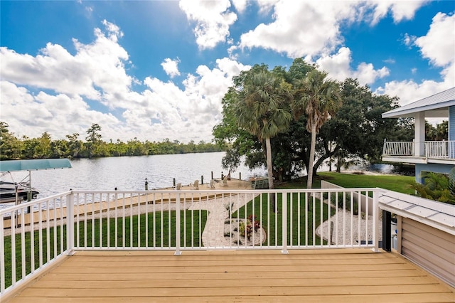 wooden deck featuring a water view and a yard