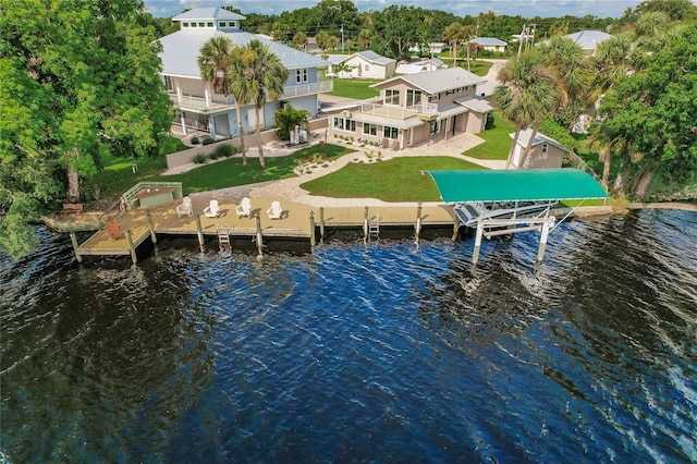 dock area with a water view, a patio area, boat lift, and a lawn