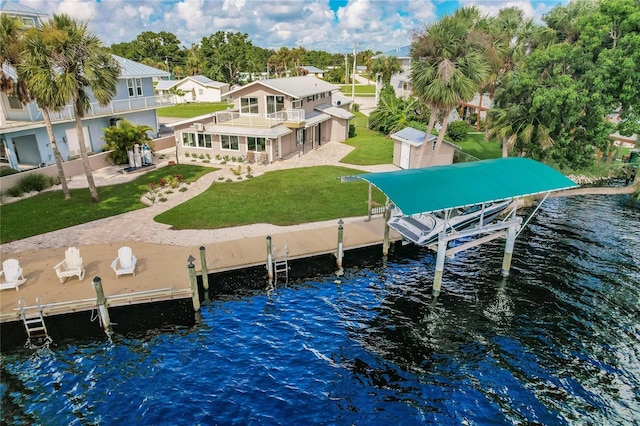 dock area with a patio, boat lift, a balcony, a water view, and a lawn