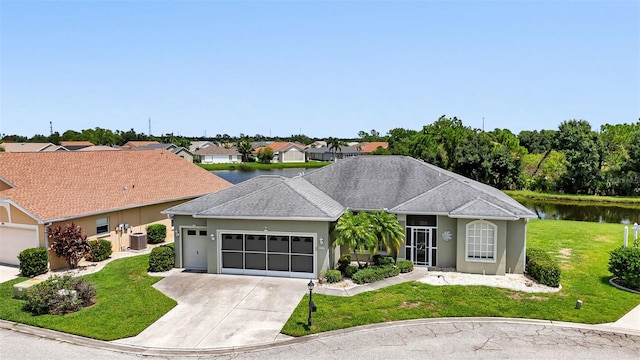 ranch-style home featuring central AC unit, a garage, a water view, and a front lawn