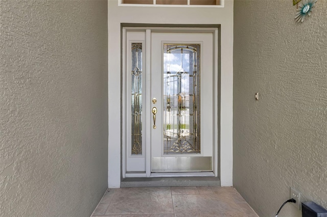 entrance to property featuring stucco siding