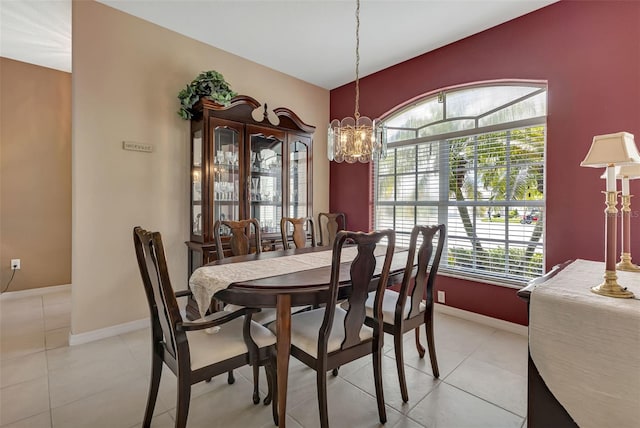 tiled dining area featuring a notable chandelier