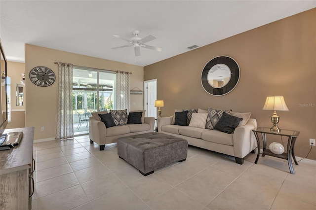 living area with light tile patterned floors, visible vents, and ceiling fan