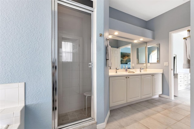 bathroom featuring tile patterned floors, an enclosed shower, plenty of natural light, and vanity