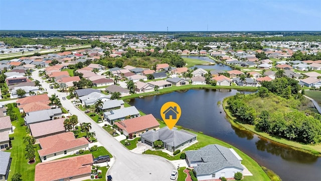 birds eye view of property with a water view and a residential view