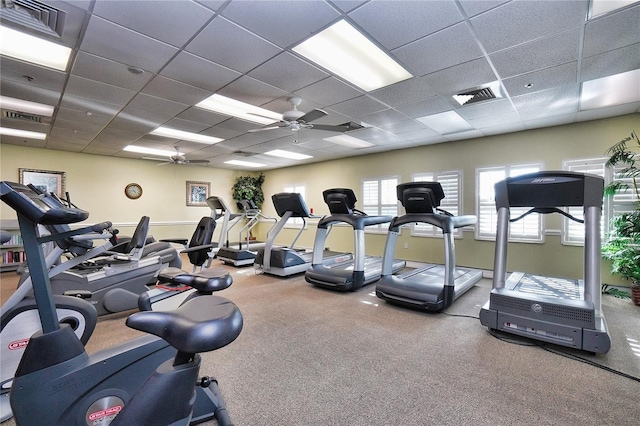 exercise room featuring a ceiling fan, visible vents, and a paneled ceiling