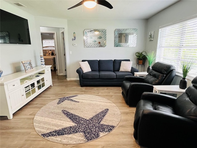 living room with ceiling fan and light hardwood / wood-style floors