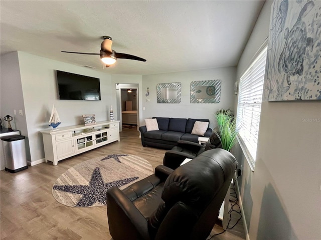 living room featuring ceiling fan and hardwood / wood-style flooring