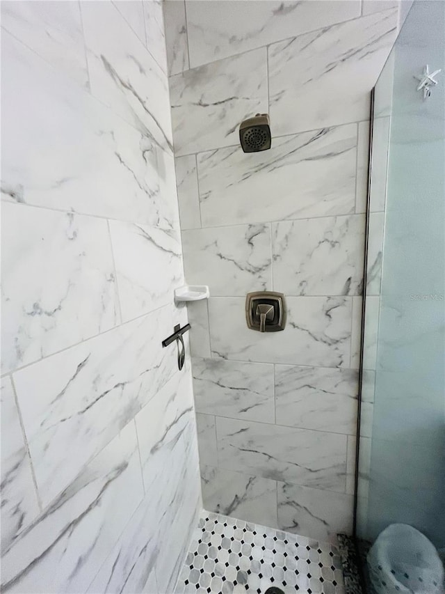 bathroom with a tile shower