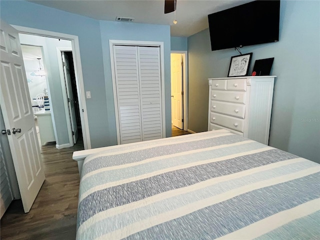 bedroom with dark hardwood / wood-style flooring, ceiling fan, and a closet