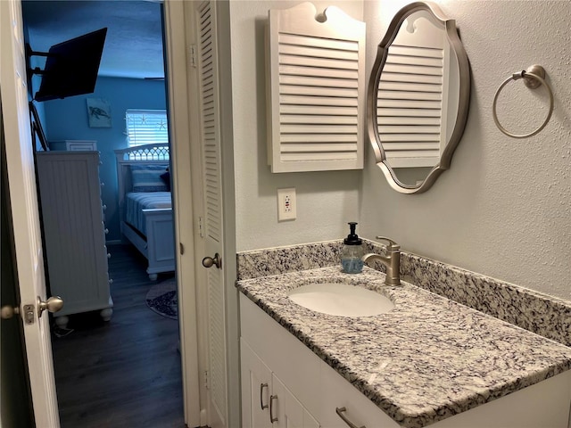 bathroom with hardwood / wood-style floors and vanity