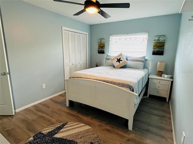 bedroom featuring a ceiling fan, a closet, dark wood finished floors, and baseboards