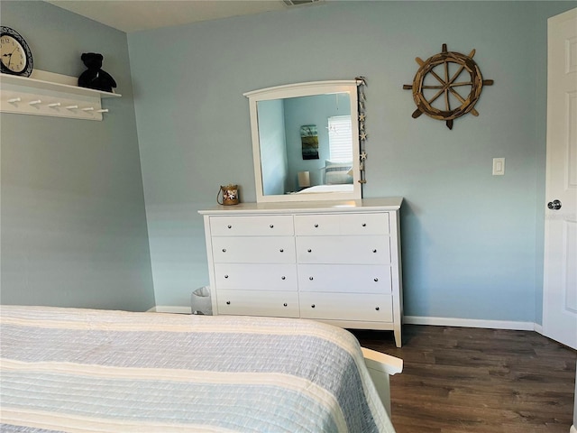 bedroom with dark wood-type flooring, visible vents, and baseboards