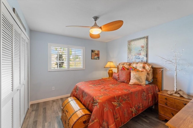 bedroom with a ceiling fan, a closet, baseboards, and wood finished floors