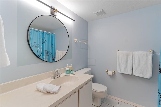 bathroom with a textured ceiling, vanity, walk in shower, tile patterned flooring, and toilet