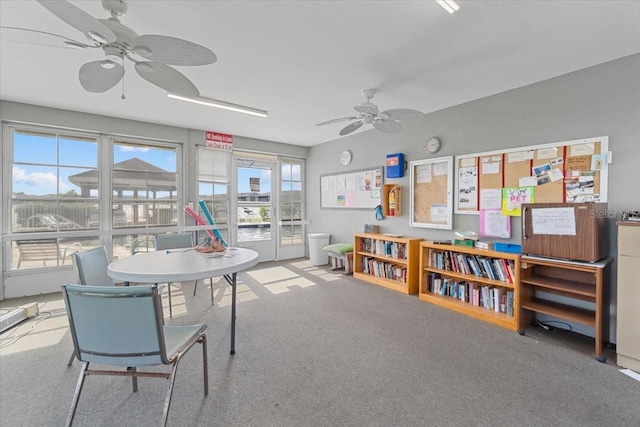 interior space with ceiling fan and carpet