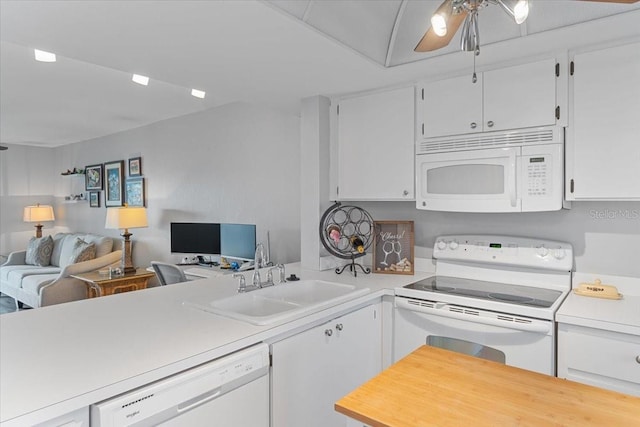 kitchen with white cabinets, white appliances, sink, kitchen peninsula, and ceiling fan