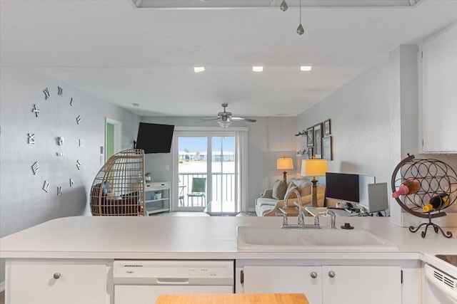 kitchen featuring white cabinetry, kitchen peninsula, sink, white dishwasher, and ceiling fan