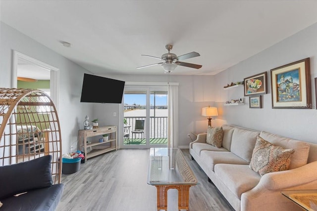 living room with hardwood / wood-style flooring and ceiling fan