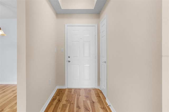 doorway to outside featuring wood finished floors and baseboards