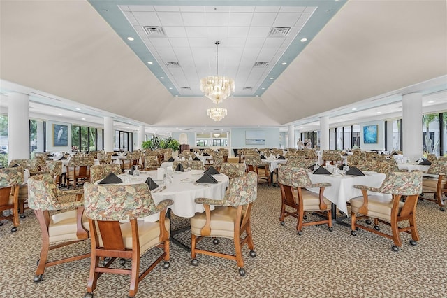 dining space with plenty of natural light, light colored carpet, and an inviting chandelier