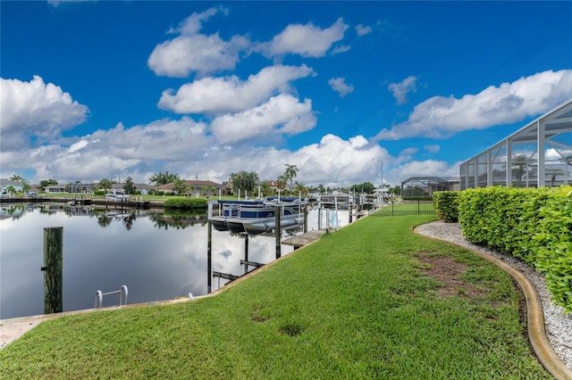 view of dock with a lawn, glass enclosure, and a water view