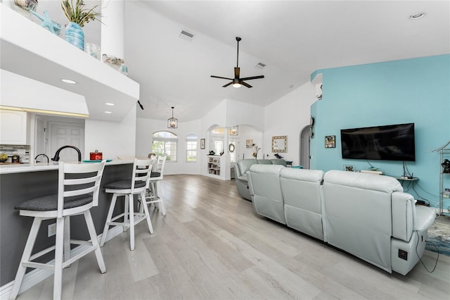 living room featuring light hardwood / wood-style flooring and ceiling fan