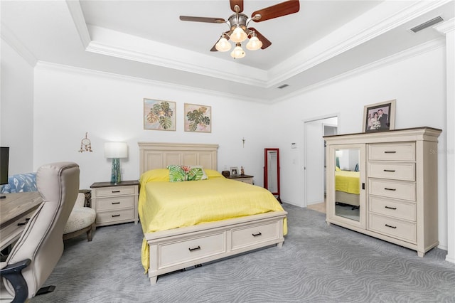 bedroom with a raised ceiling, ornamental molding, carpet flooring, and visible vents