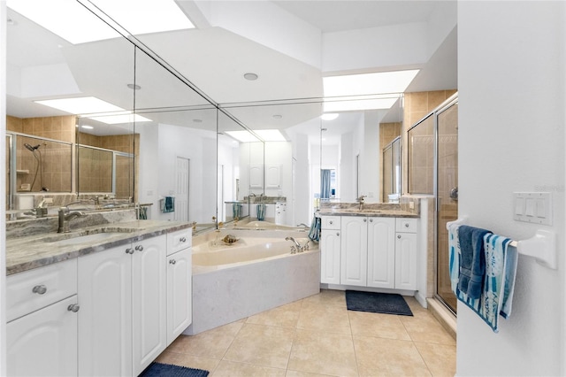 bathroom with tile patterned floors, vanity, and independent shower and bath