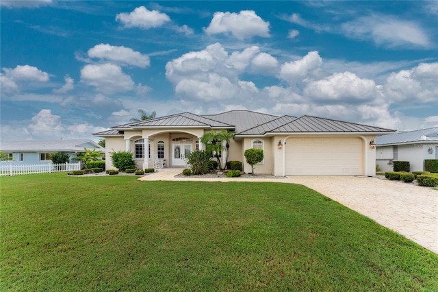 view of front of house featuring a front yard and a garage