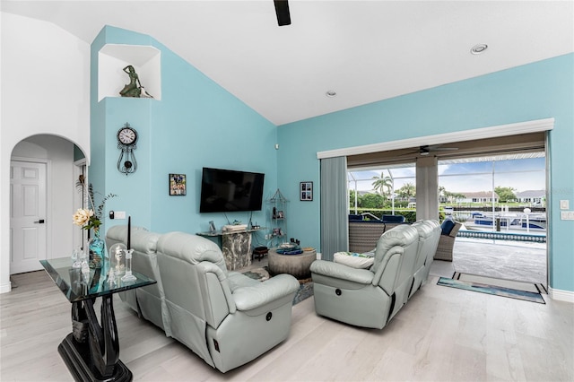 living room featuring light hardwood / wood-style floors and high vaulted ceiling