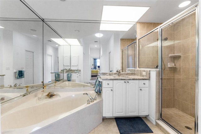 bathroom with tile patterned flooring, vanity, and independent shower and bath