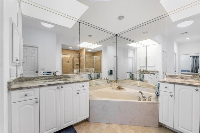 bathroom with tile patterned flooring, vanity, and separate shower and tub