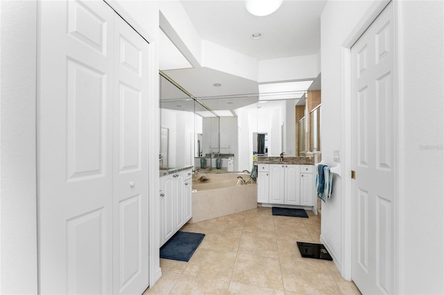 bathroom with tile patterned flooring, vanity, and plus walk in shower