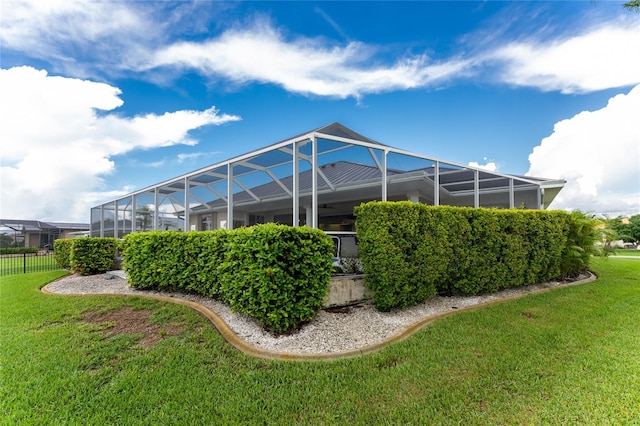 exterior space with a lanai and a yard