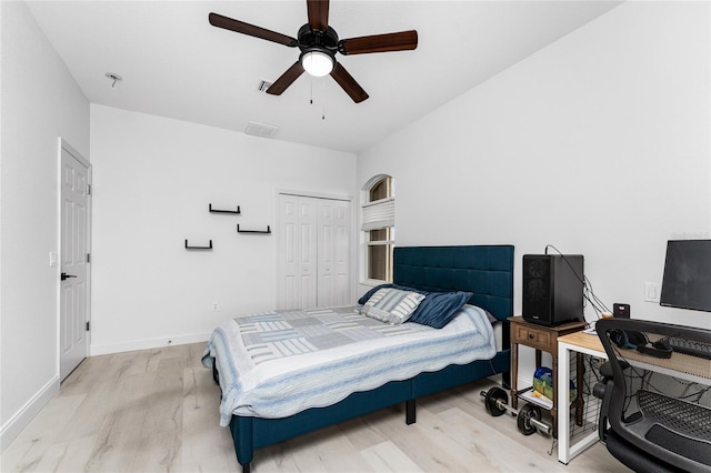 bedroom with ceiling fan, a closet, and light wood-type flooring