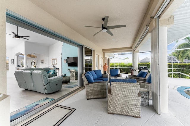 view of patio / terrace with outdoor lounge area, glass enclosure, and ceiling fan